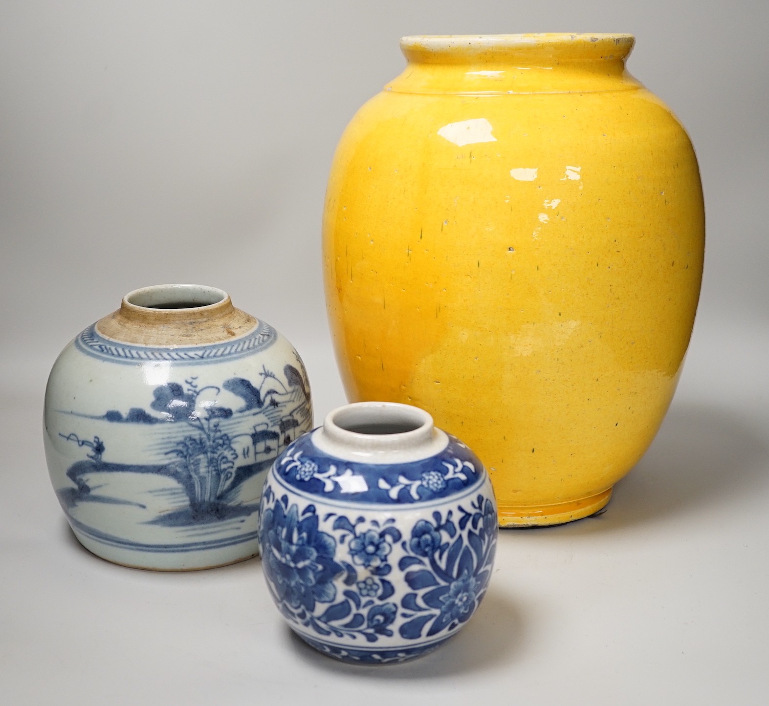 Two Chinese blue and white ginger jars, together with a large Chinese yellow glazed vase, tallest 31cm